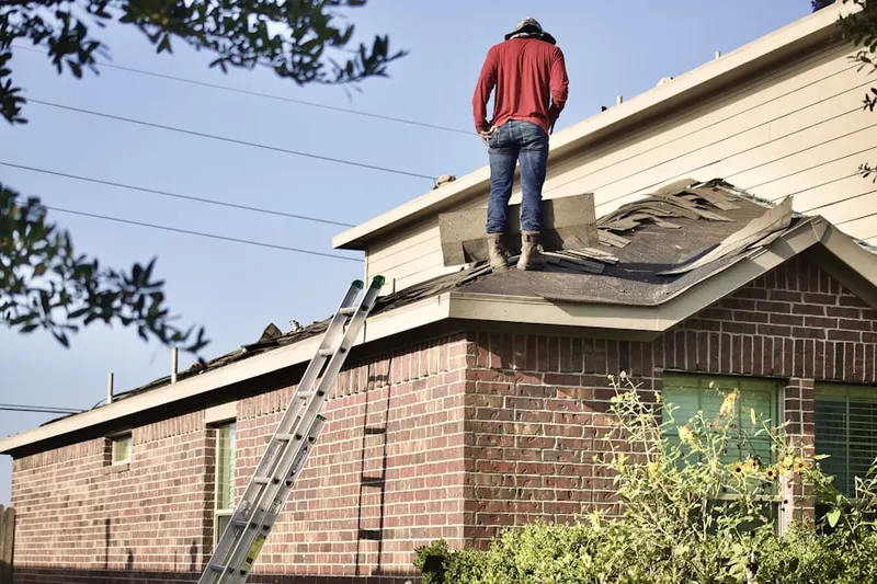 Professional roofer working on a residential roof in Whispering Woods